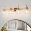 CLAVIE Gold Bathroom Light Fixtures 4-Light 28 in. W x 9 in. H Wall Sconces with Clear Glass Shade Vanity Light in Black